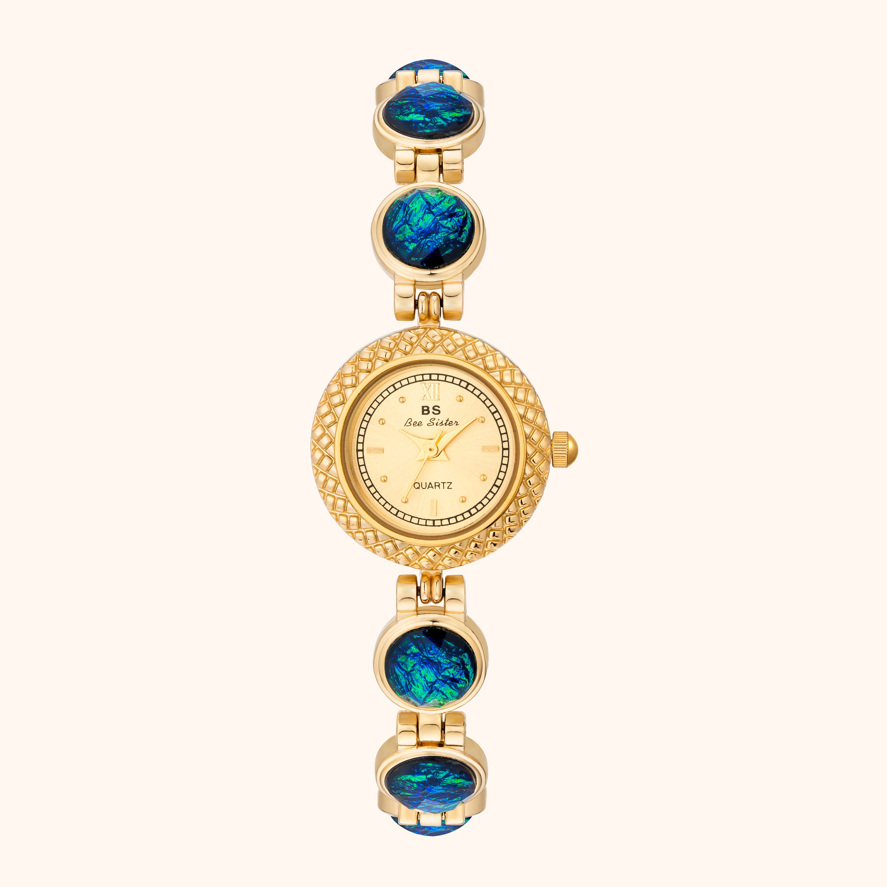 Orologio in oro con pietre opalescenti su fondo bianco