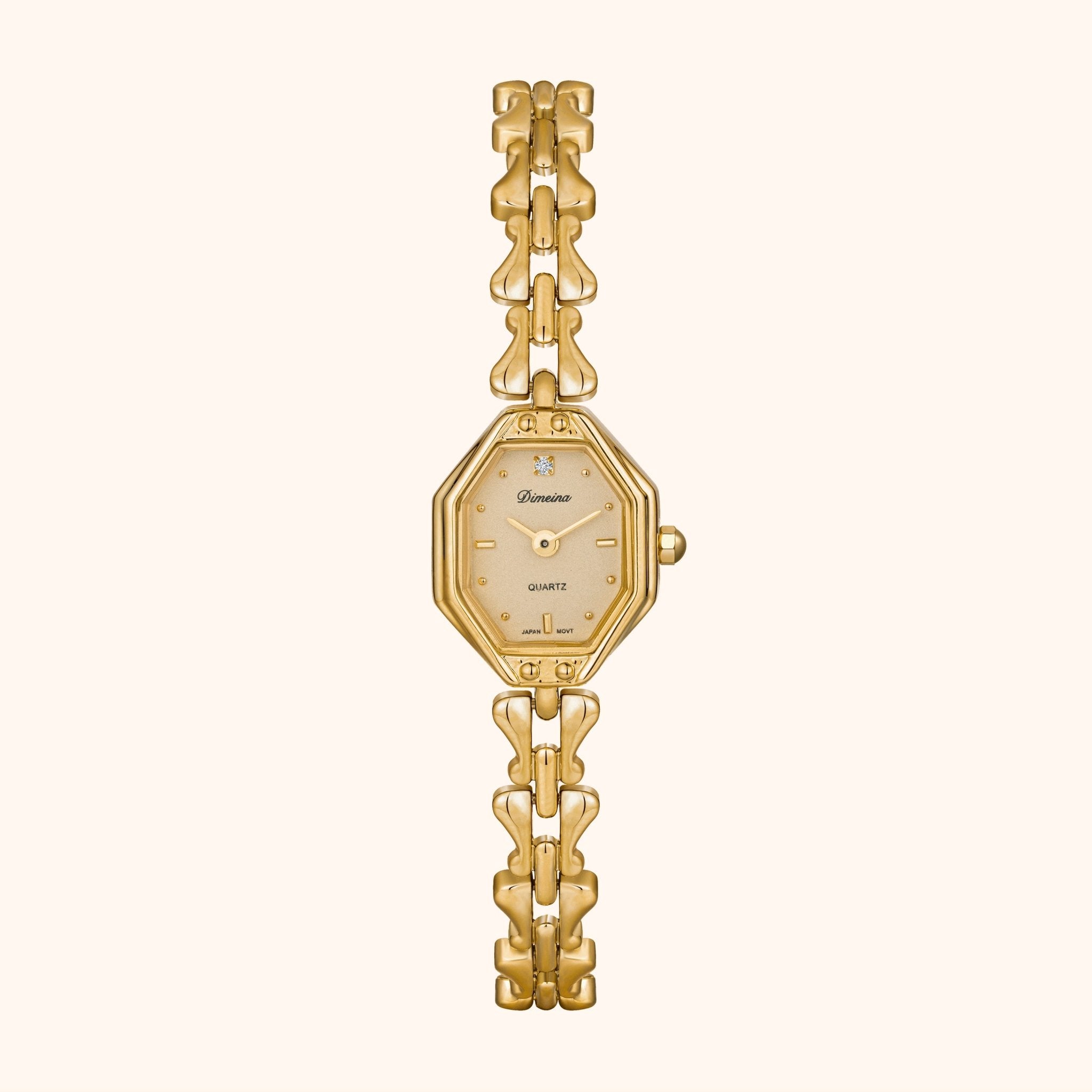 Gold wristwatch with a chain strap on a white background