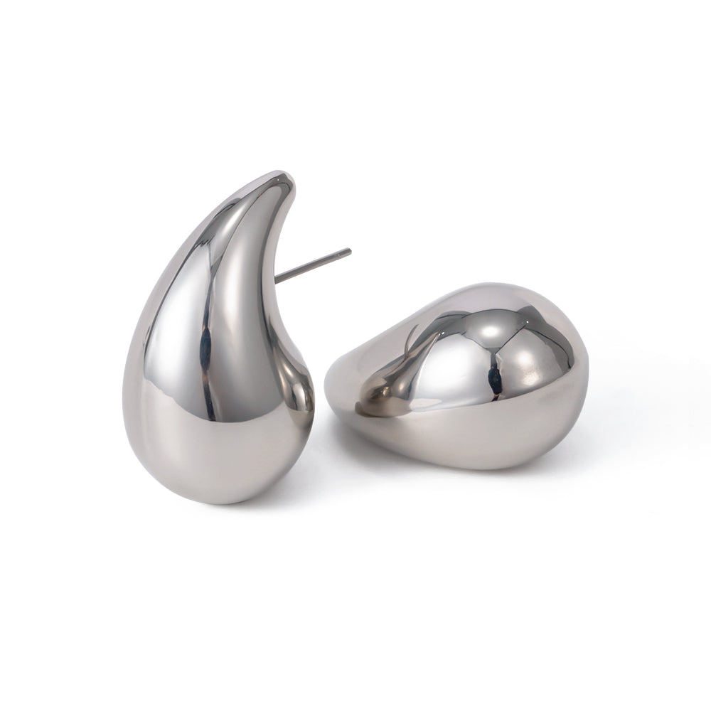 Pair of silver teardrop-shaped earrings on a white background