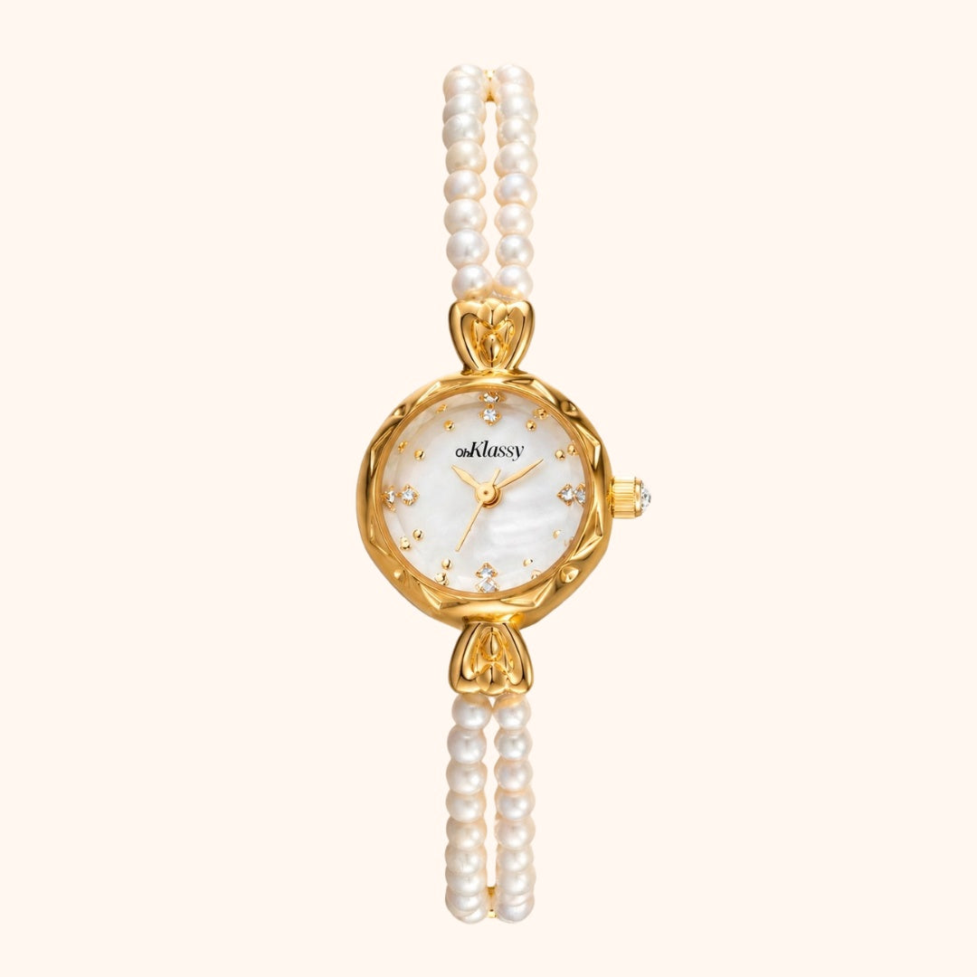 Gold watch with pearl strap on a white background