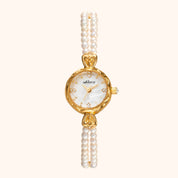 Gold watch with pearl strap on a white background
