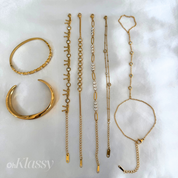 Set of gold jewelry including bracelets and a ring on a white background with 'oh Klassy' branding.